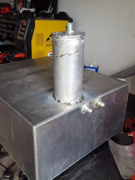 Big sump welded onto fuel tank.