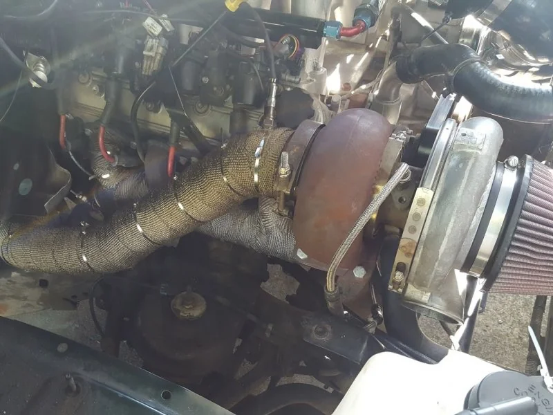 Finished downpipe wrapped in titanium exhaust wrap.