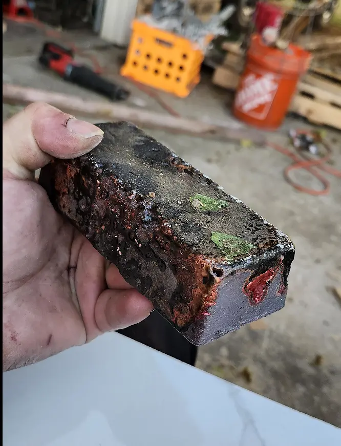 Picture of copper ingot covered in flux