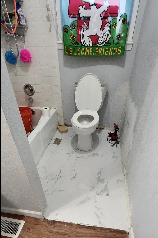 Picture showing grout layed, with drywall repair in progress.