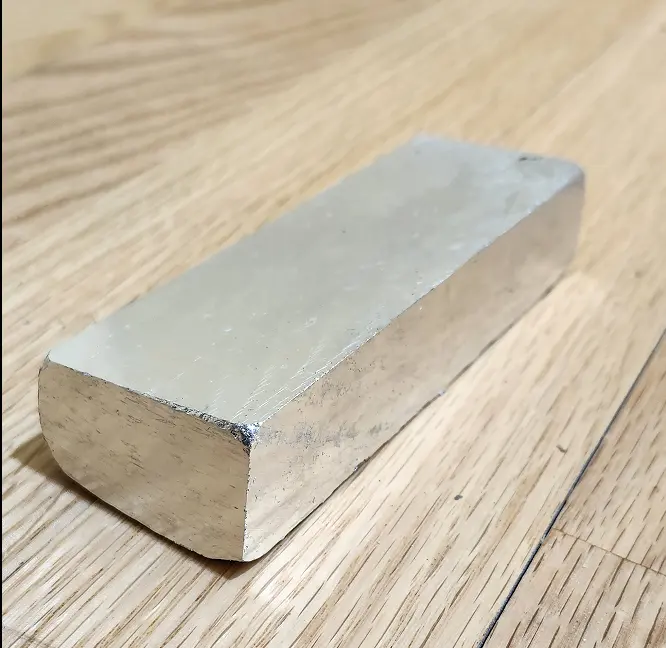 Picture showing aluminum ingot with sides sliced off. Very shiny.