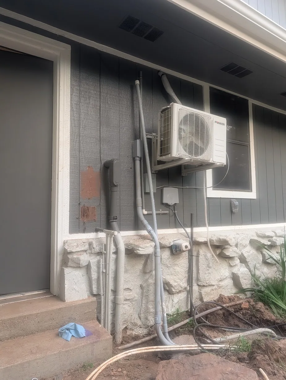 Exterior wall by the mini-split with only the original 1.5" EMT run to the shop in place