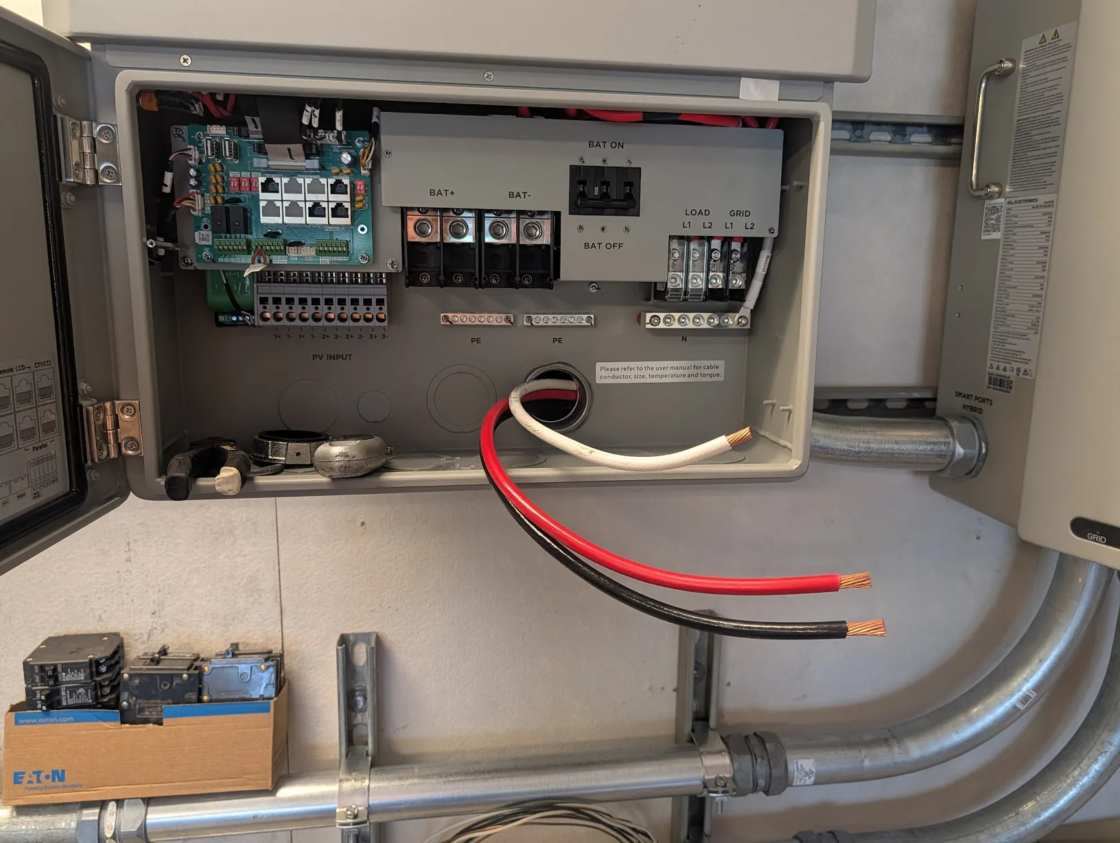 FlexBoss21 opened up with the red/white/black 2 AWG conductors pulled in from below, stripped and ready to land