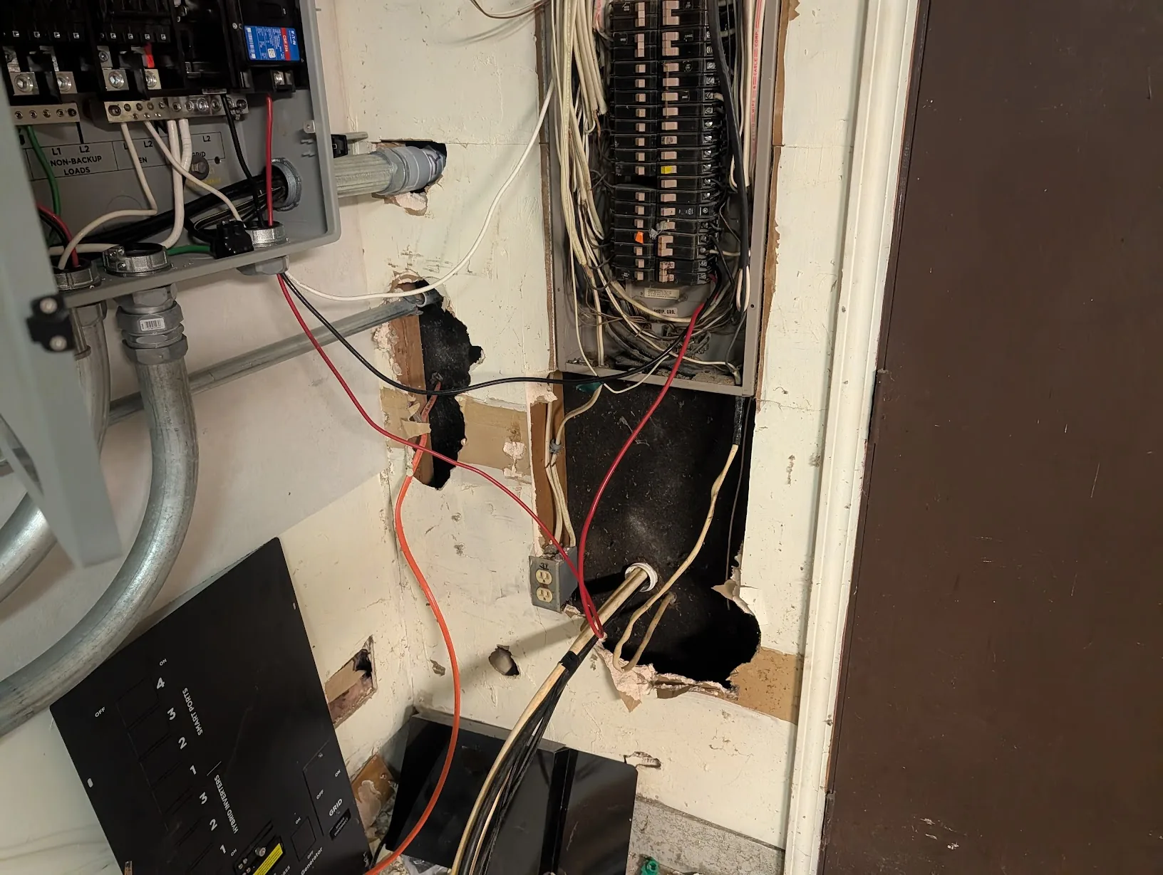 Interior side of the wall showing the incoming feeders landed on the existing panel