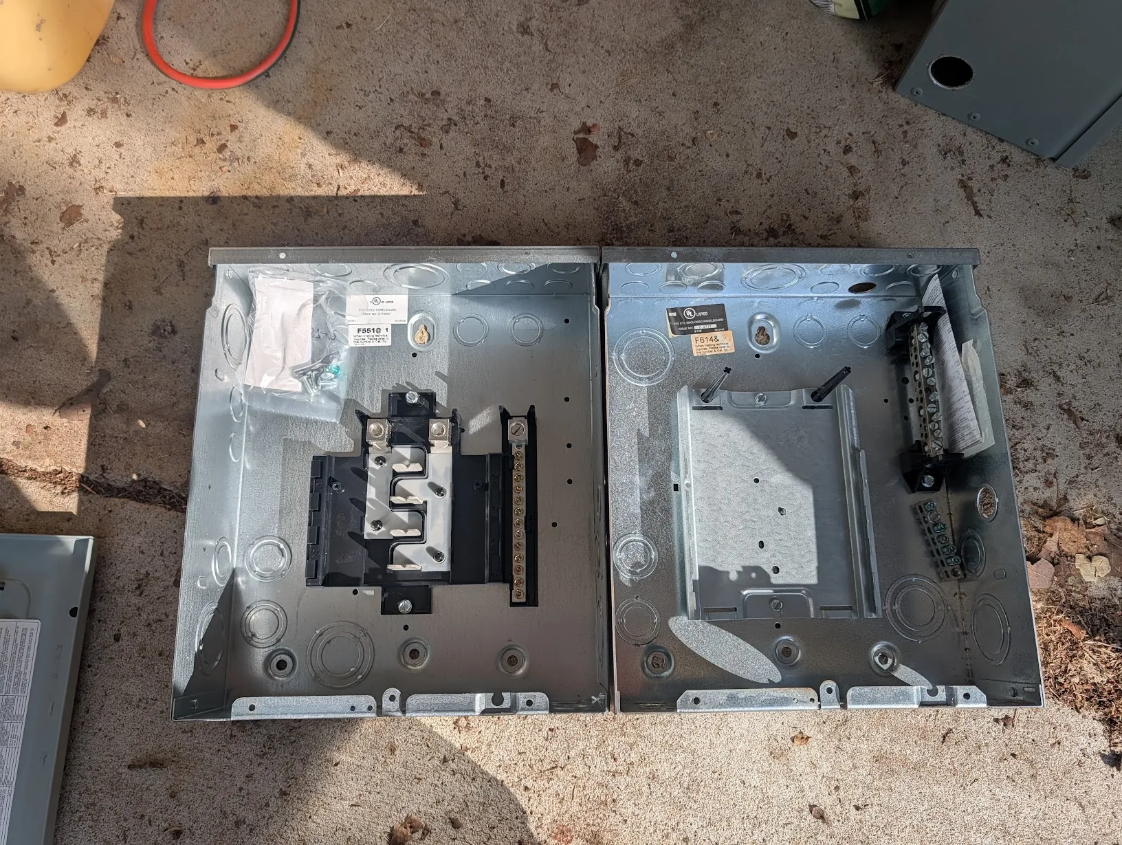 Old subpanel next to the new larger panel on the shop floor for size comparison