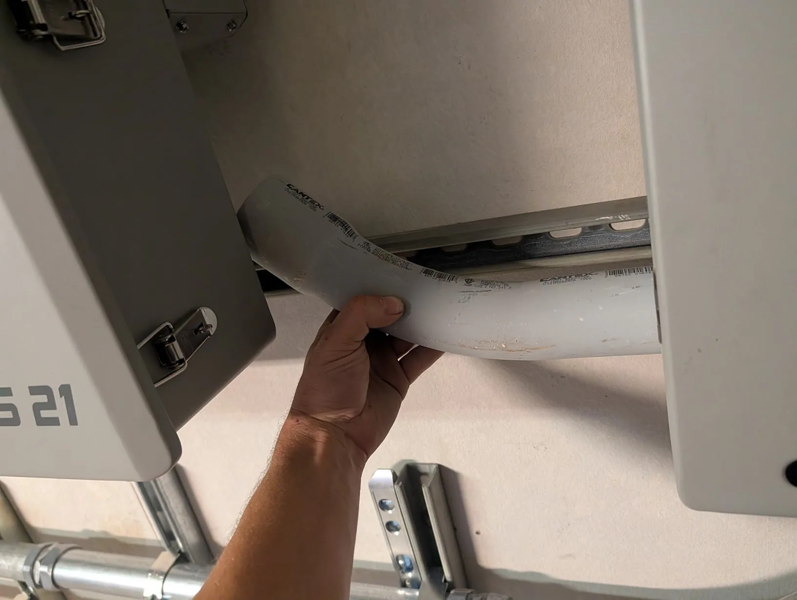 45-degree PVC elbow held in place between the GridBoss and FlexBoss as a sanity check on the routing