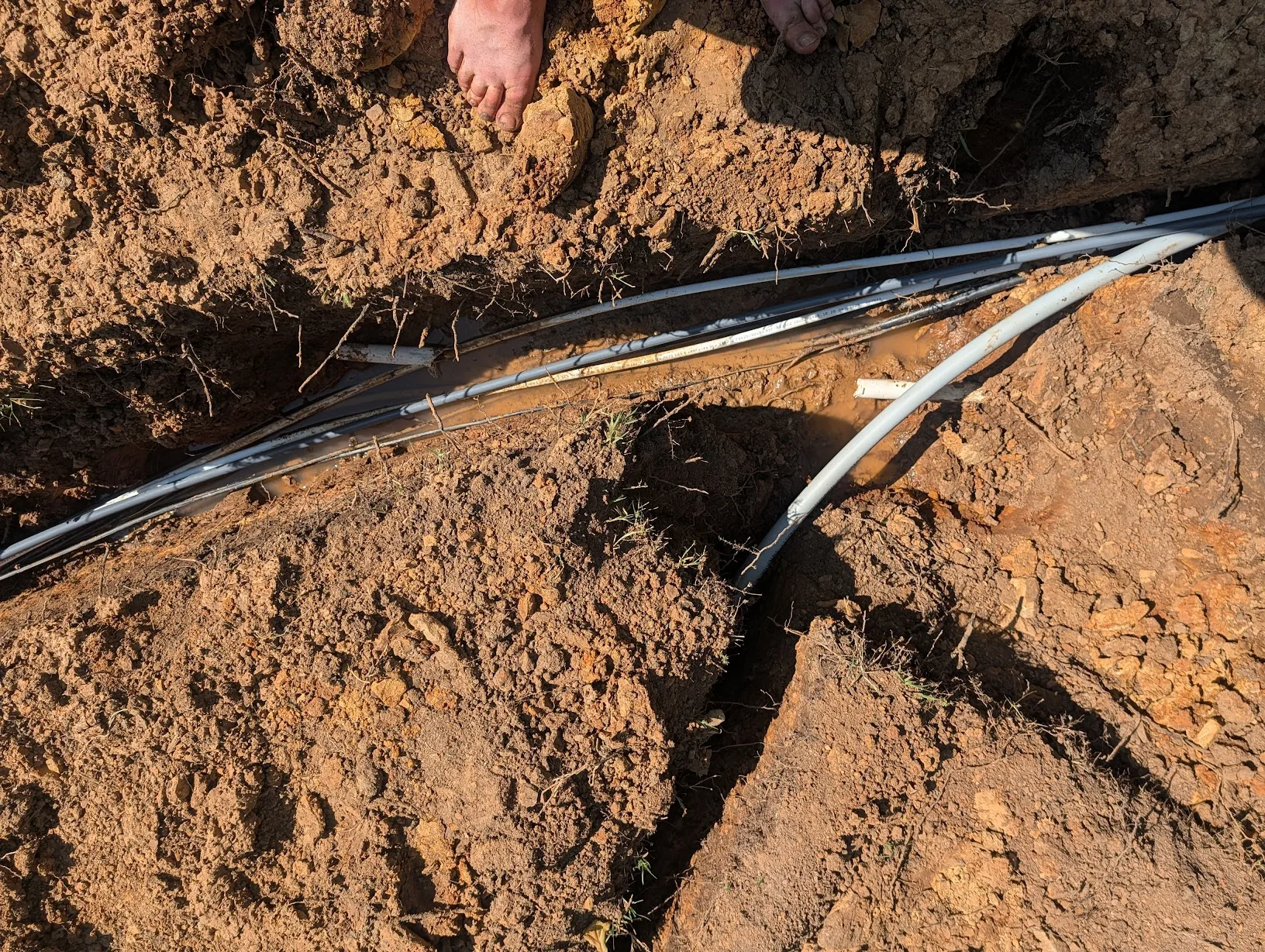 Severed water line in the trench from the trenching machine