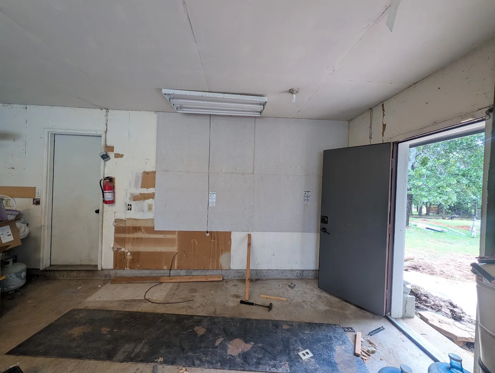 HardieBacker cement board installed across the bare garage wall