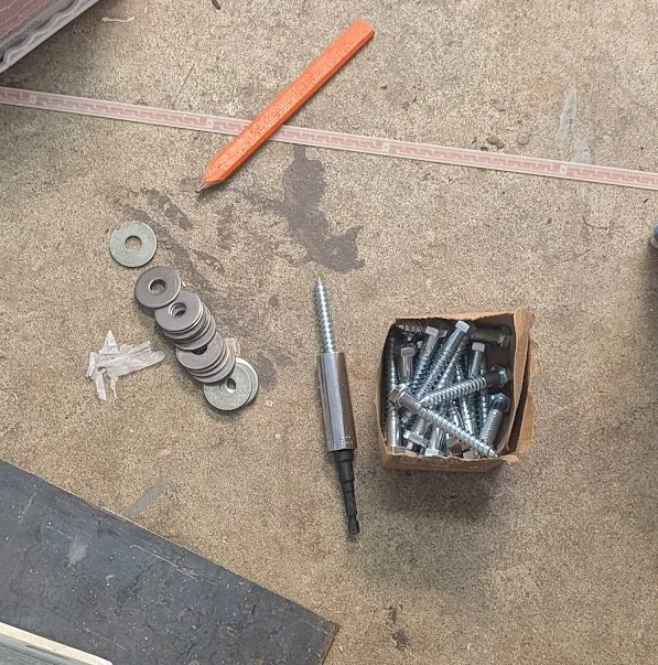 Lag bolts, washers and strut channel hardware laid out for install
