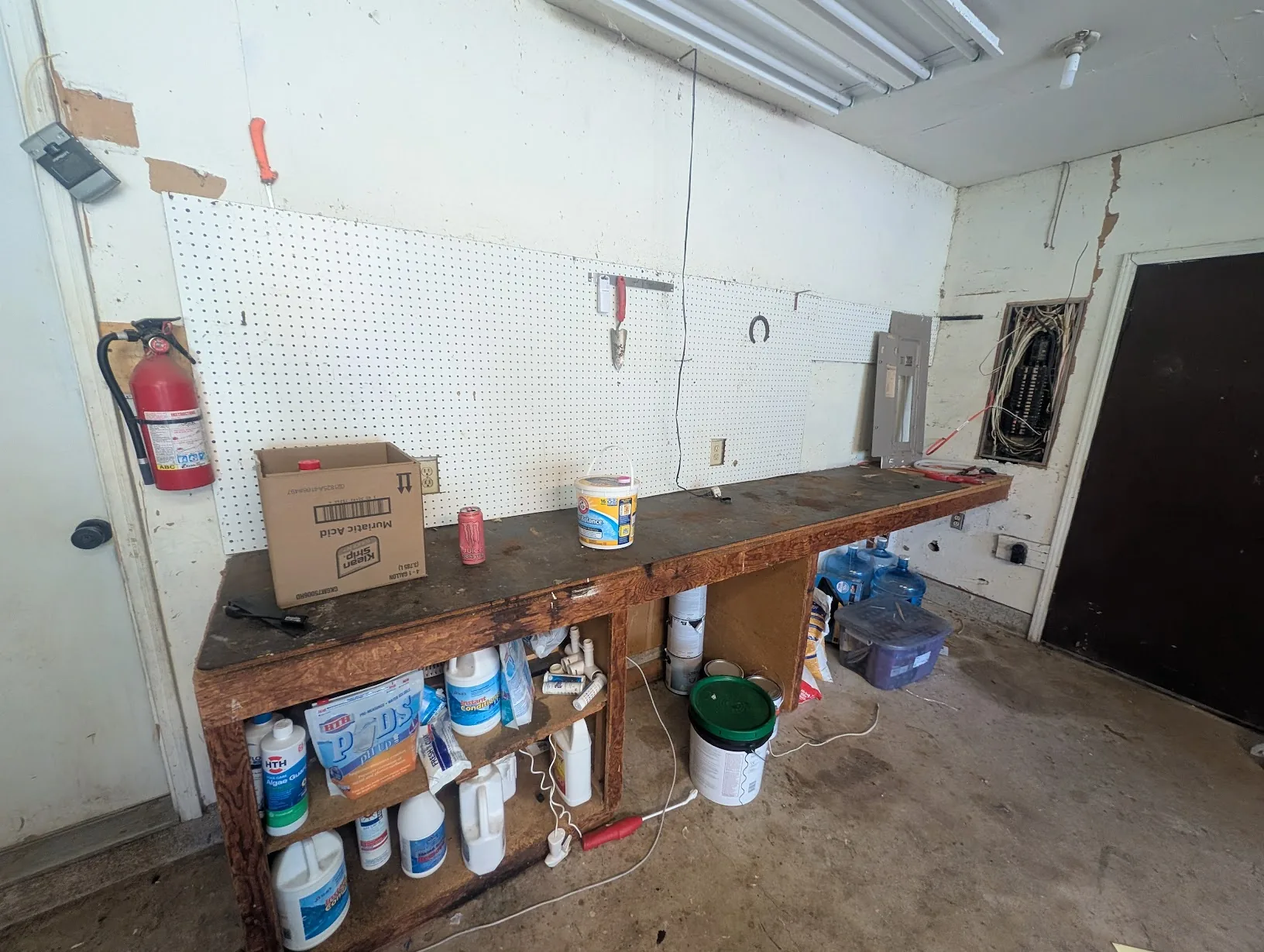 Old wooden workbench/shelf along the garage wall before demolition