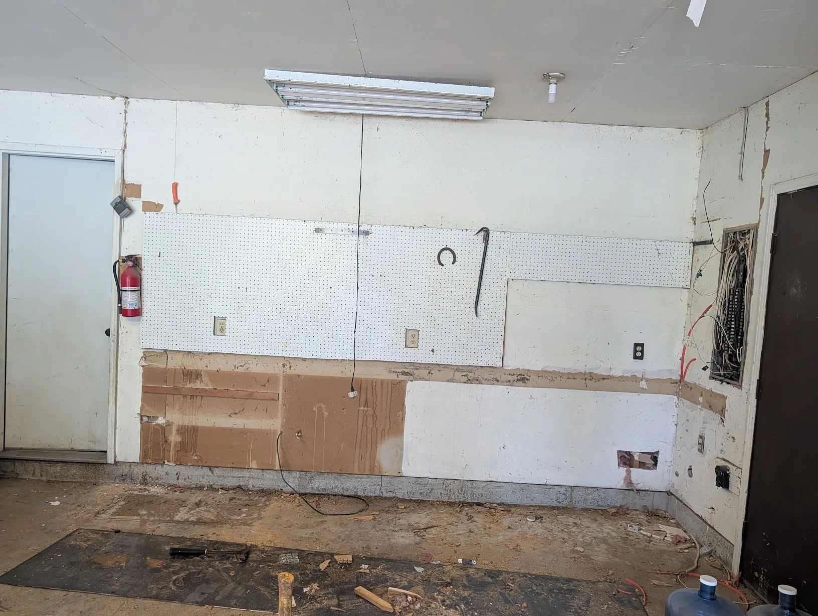 Bare garage wall with the workbench fully removed