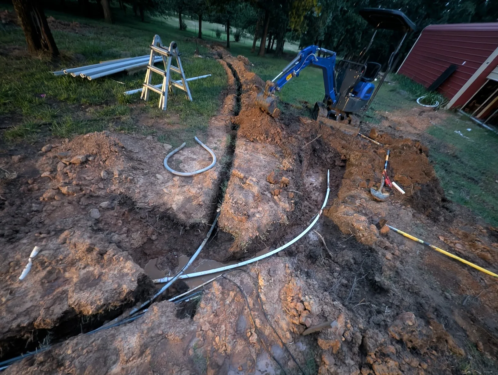 New PVC section flexed into the 45° bend to complete the repair