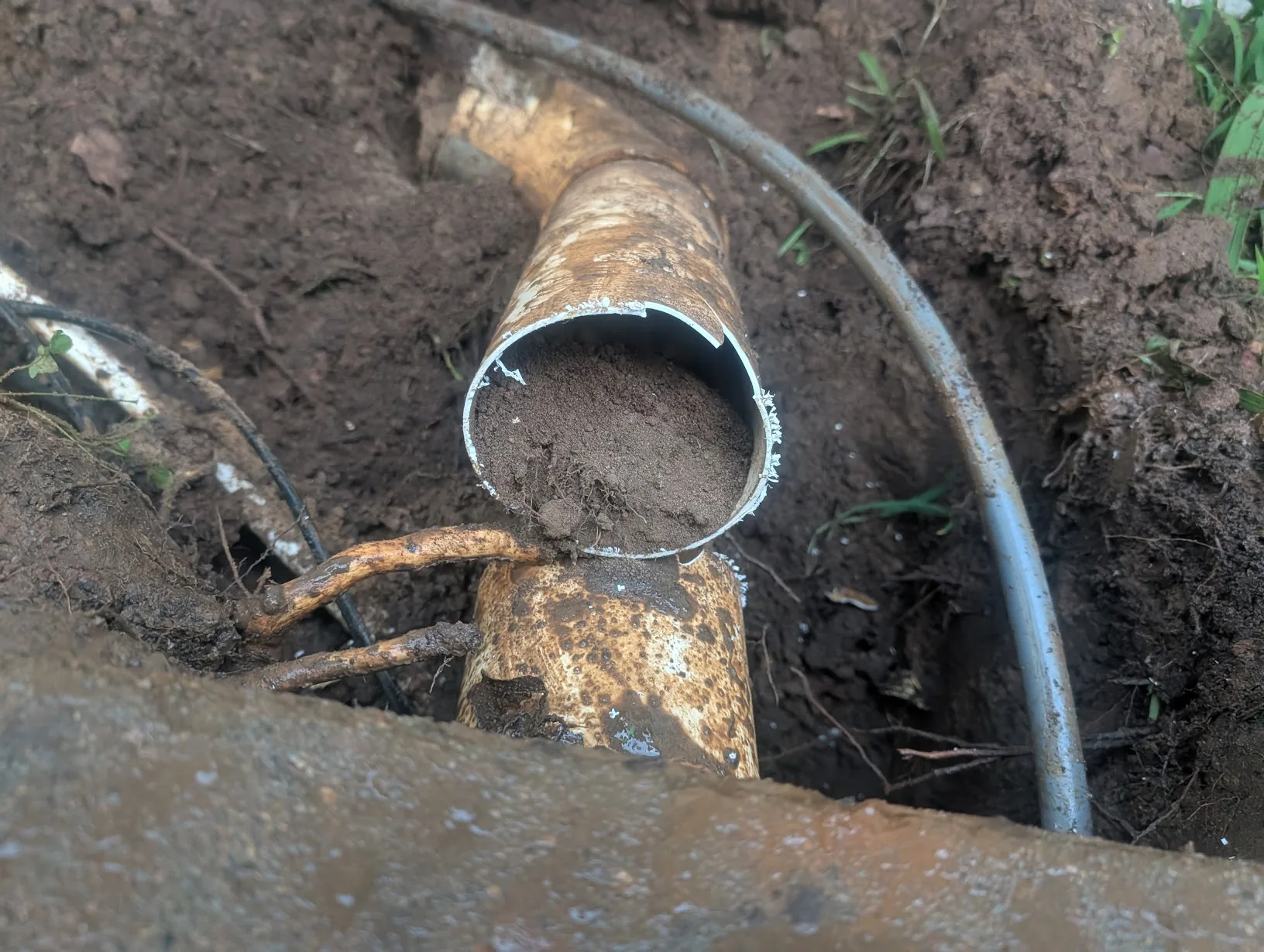 Old PVC after cutting it open — full of dirt and unused