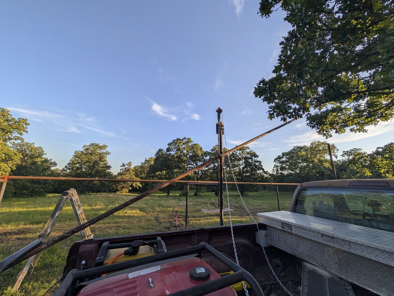 Section of drill tube being hoisted up to the top of the frame