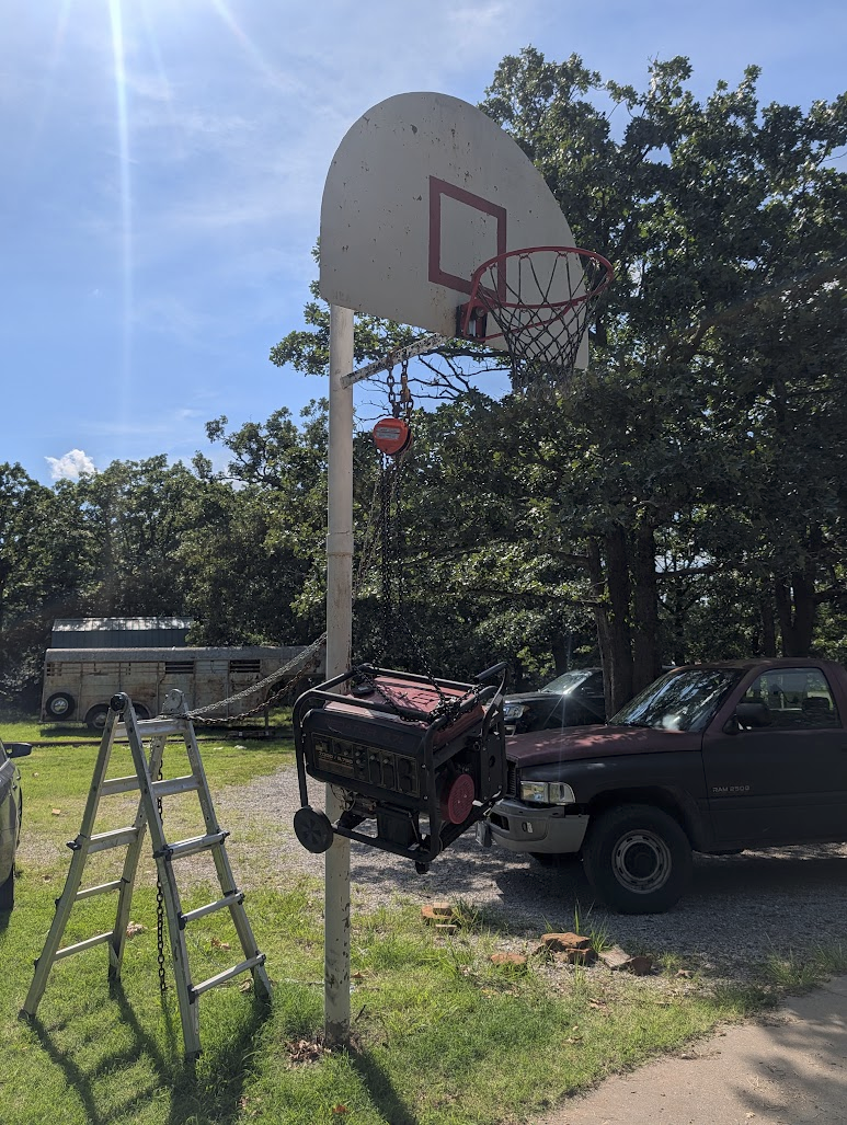 Generator lifted off the ground with a chain hoist