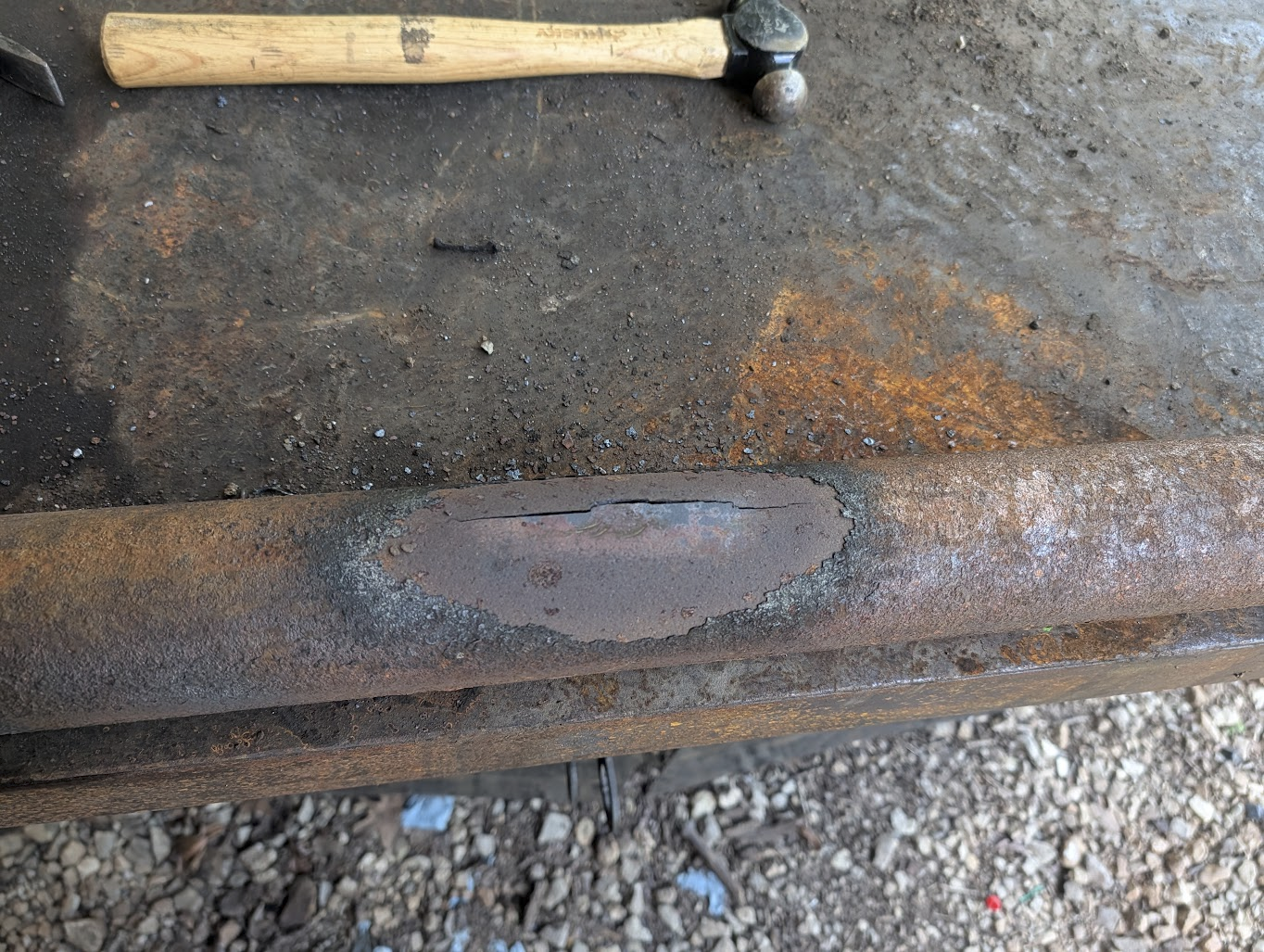 Scale burned off the pipe, leaving clean bare metal at the joint