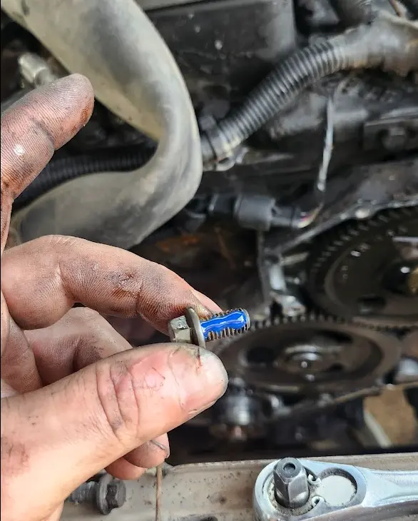 One of the timing bolts removed with loctite applied, ready for reassembly
