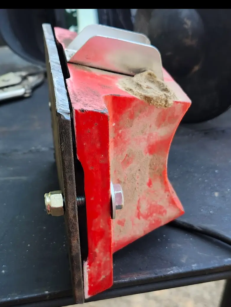 The base of the bench grinder bolted to the plate