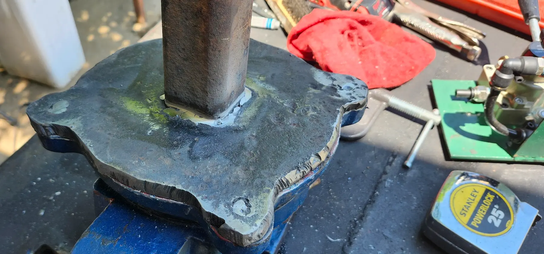 PHoto showing the bottom of the mounting plate after sanding and grinding everything flat