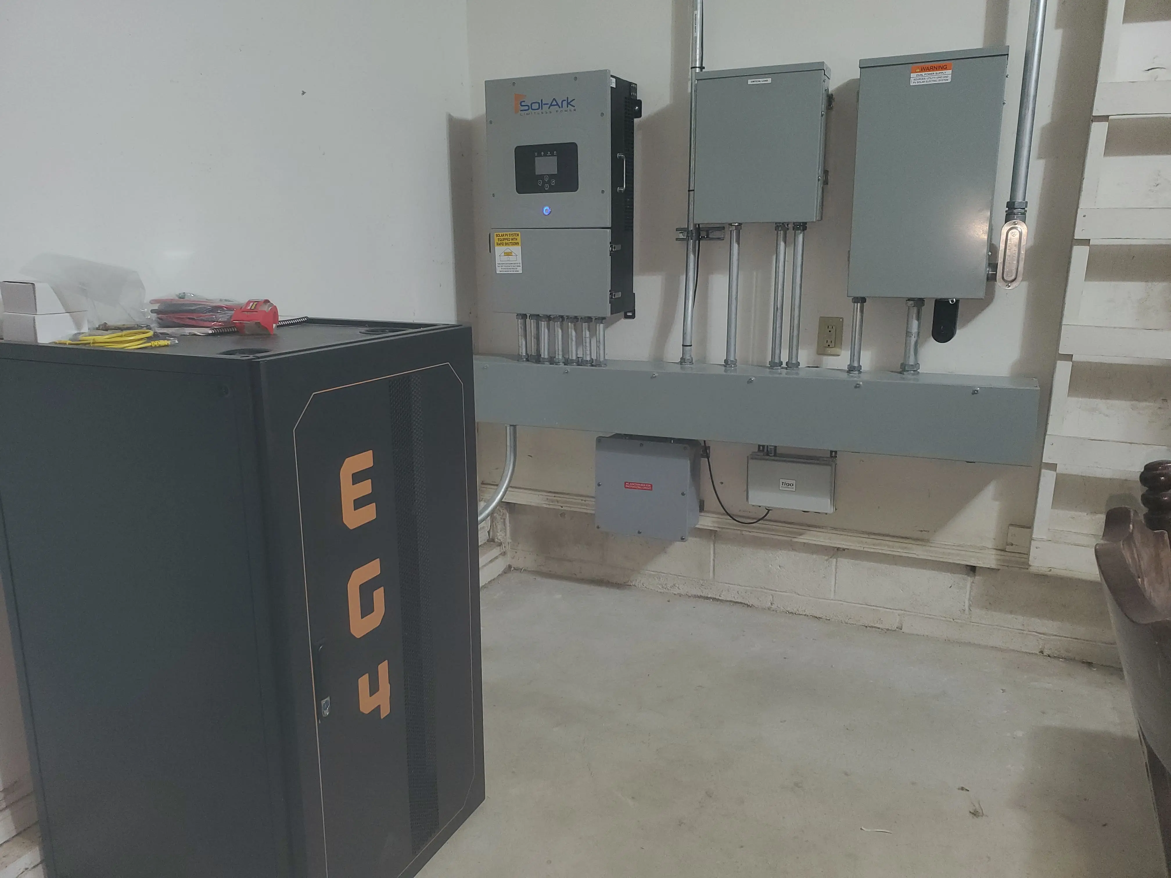 Picture of my mains panels, inverter, batteries, and other electrical gizmos in the garage