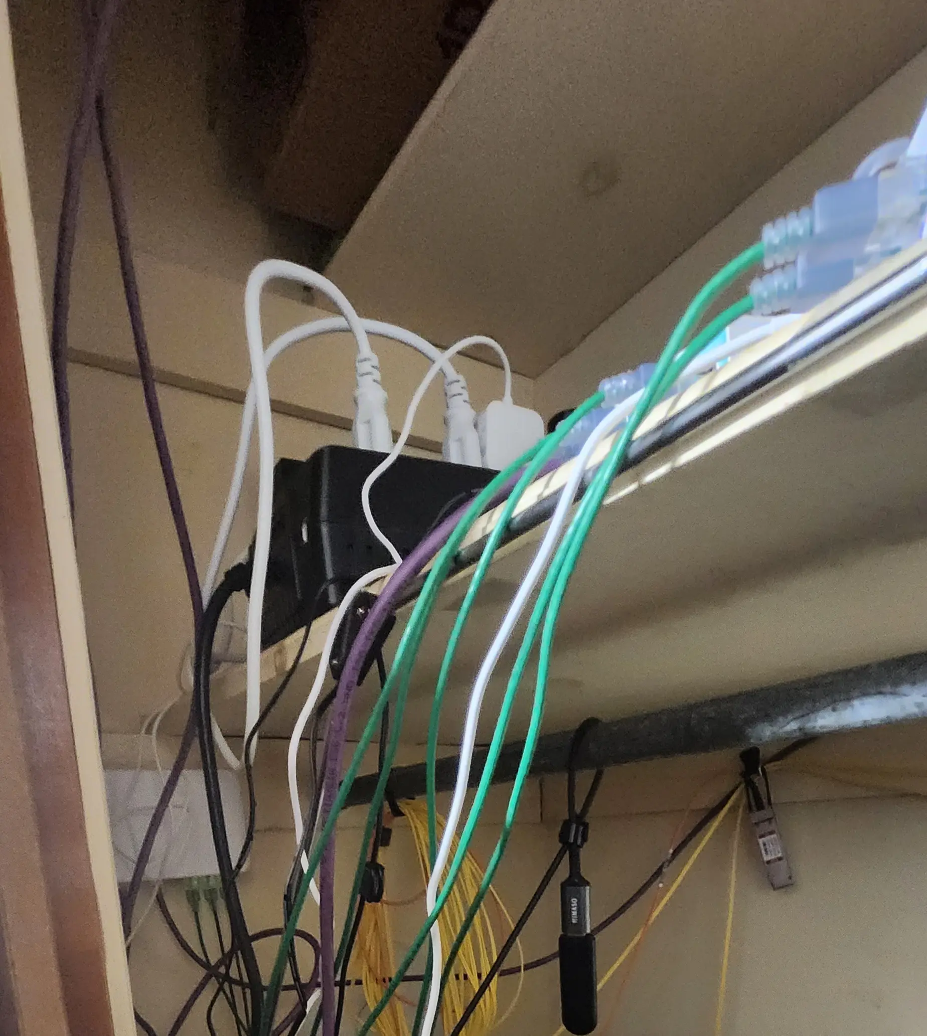 Picture of cables and hardware all over shelf